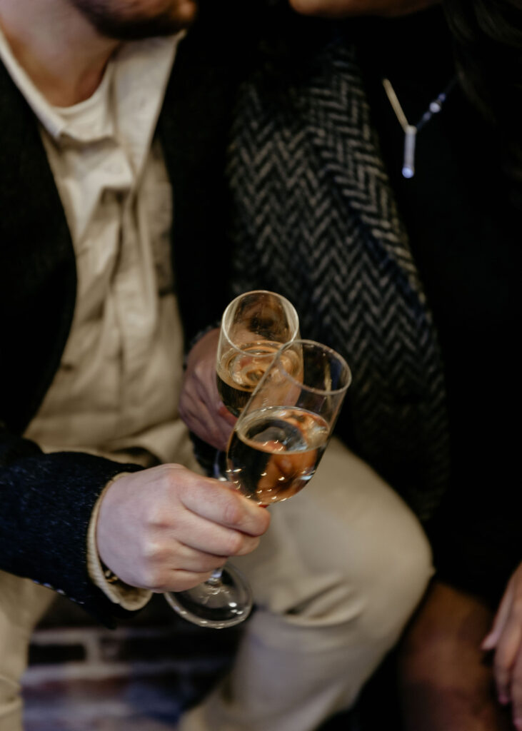 Champagne toast photo during the couples New York city engagement session