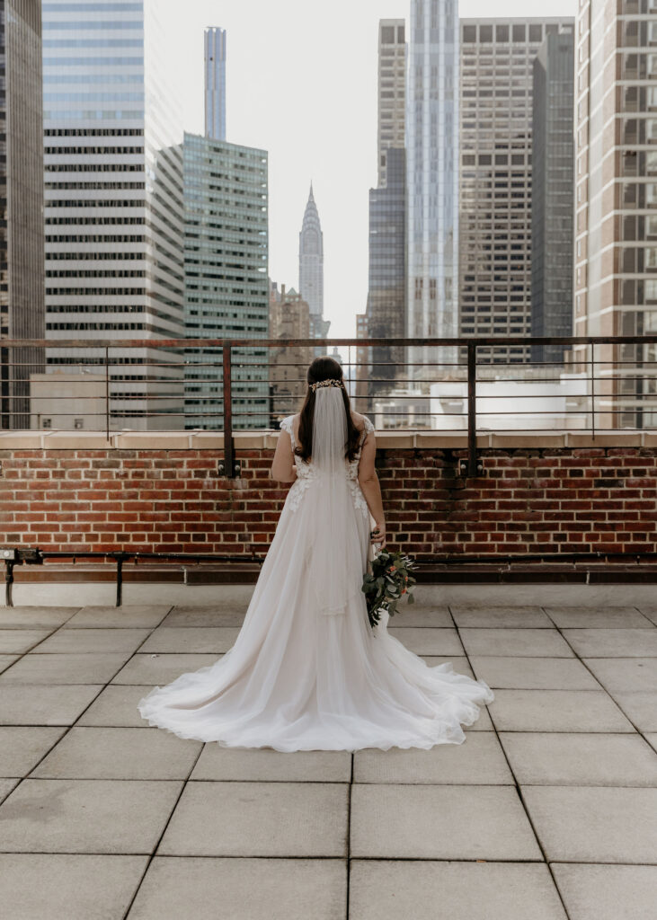 Beautiful Bride standing on Tribeca Rooftop with New York Skyline in the background