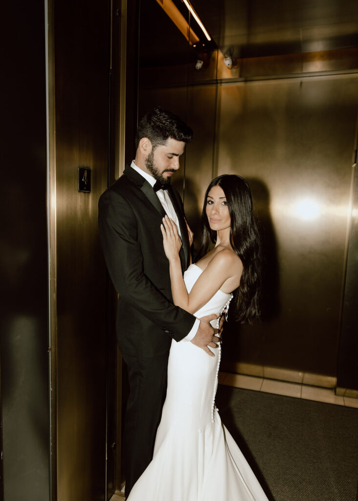 Bride and groom photo in an elevator during their New York hotel wedding photoshoot