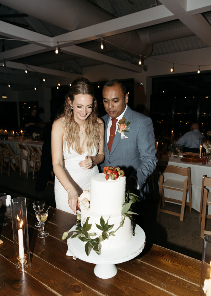 bride and groom cutting cake