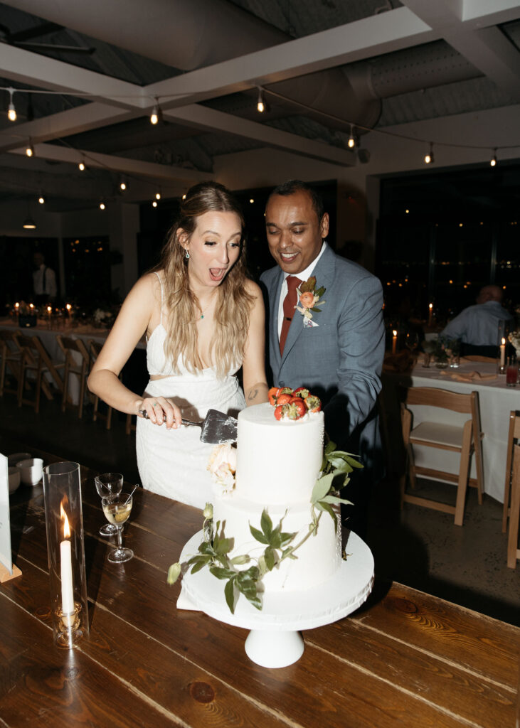 bride and groom cutting cake