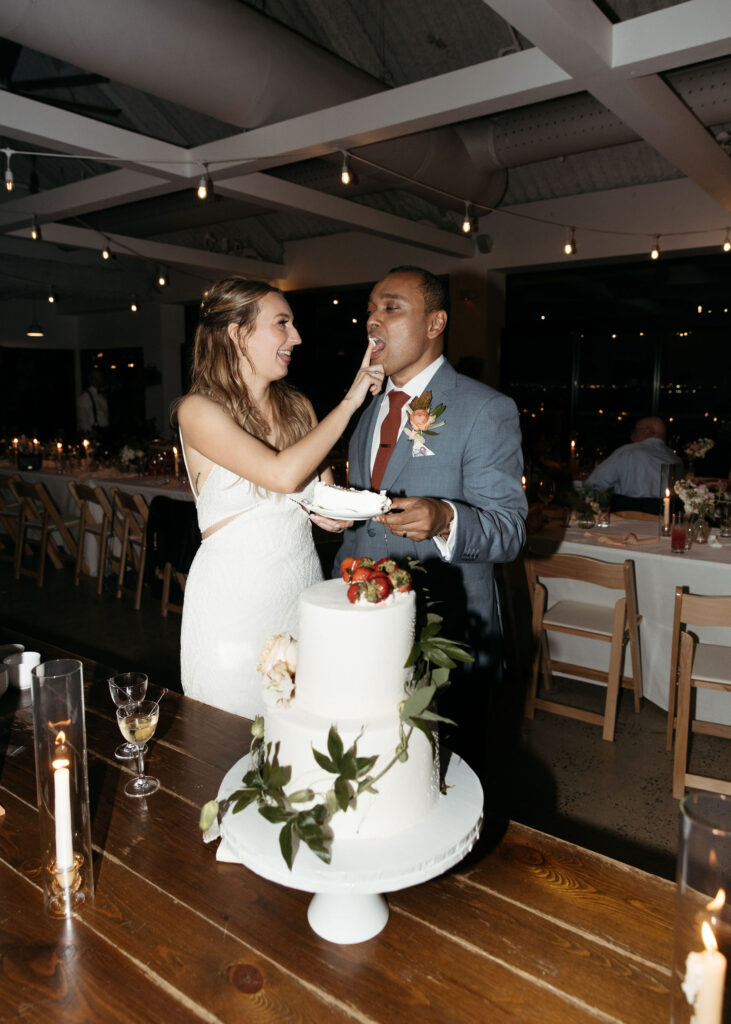 bride and groom cutting cake