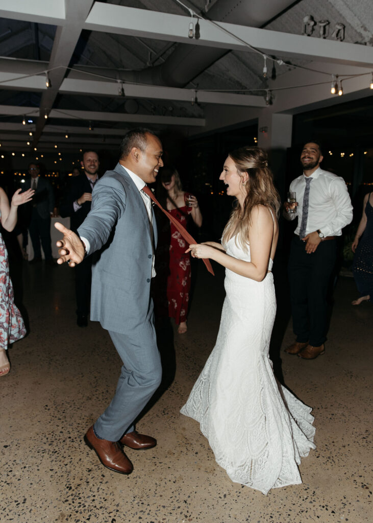 bride and groom dancing and having fun at their wedding reception