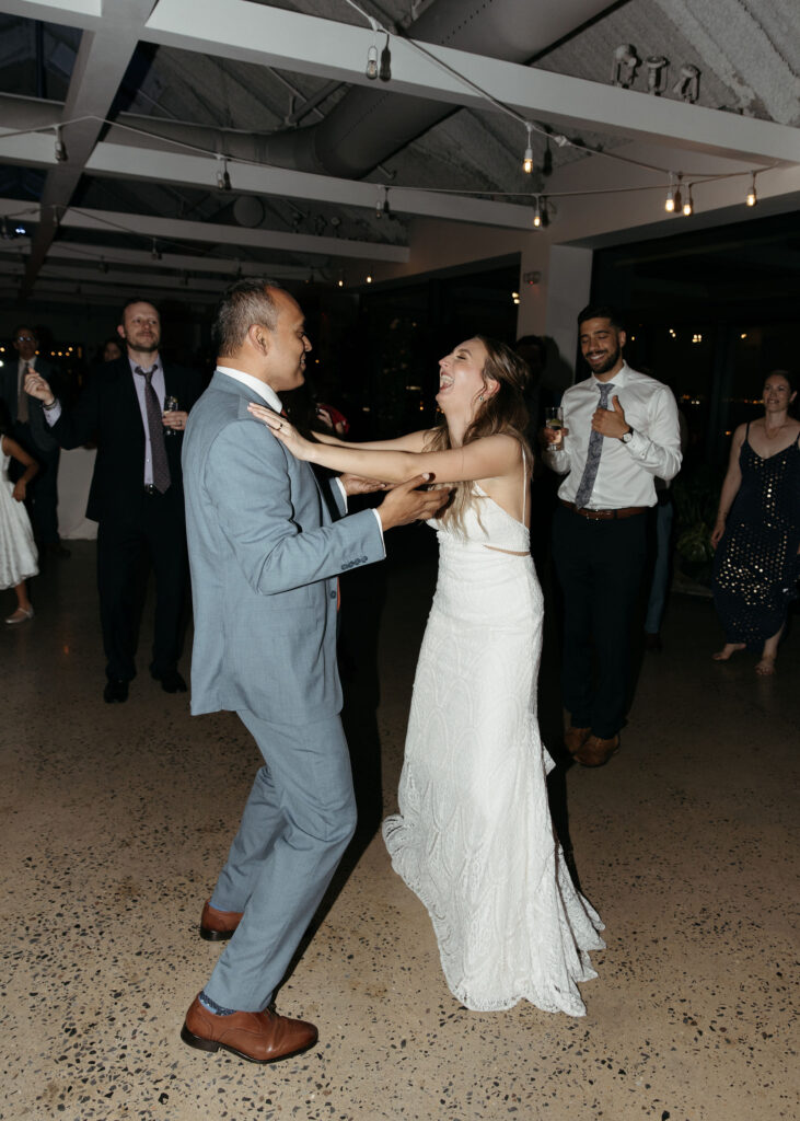 bride and groom dancing and having fun at their wedding reception