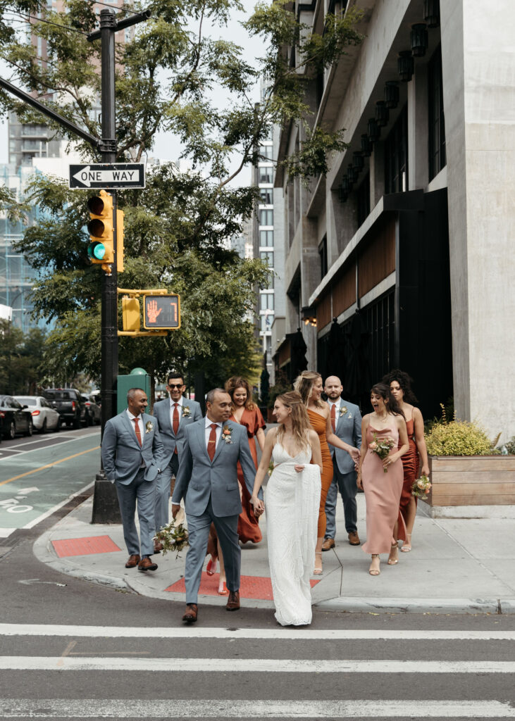 bride and groom and their wedding party roaming downtown brooklyn