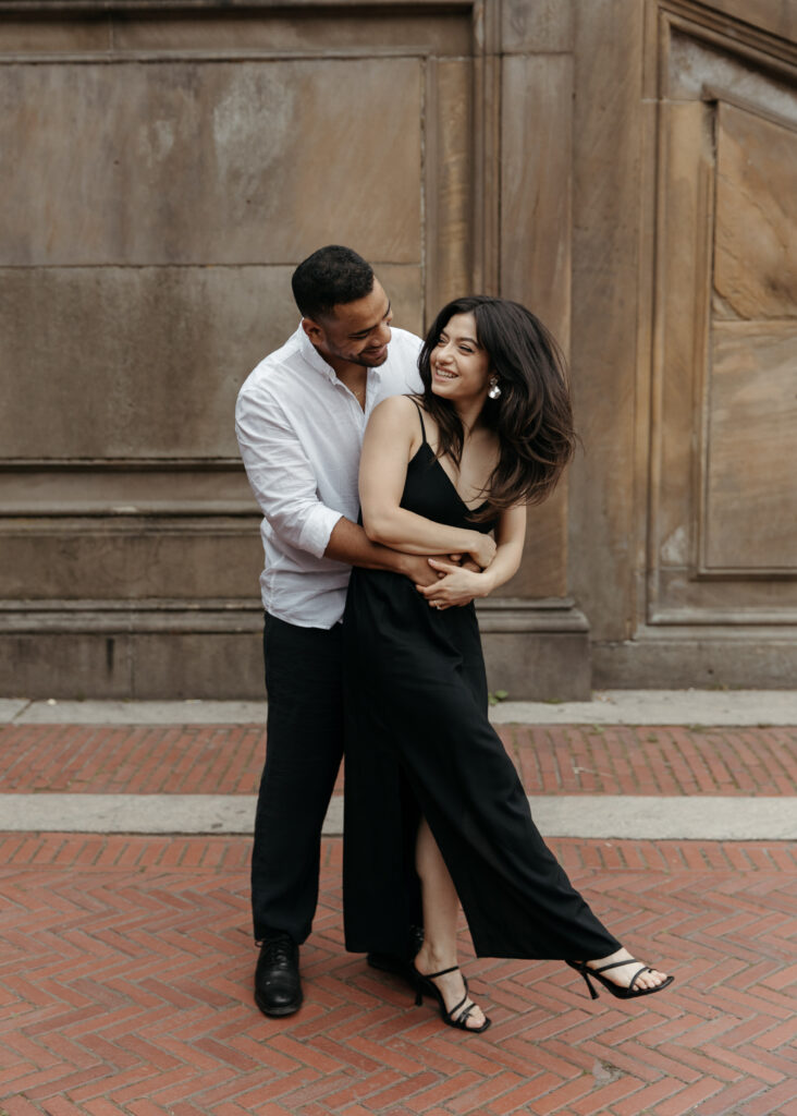 Central park engagement photos at Bethesda terrace with sleek black dress and classy casual vibes