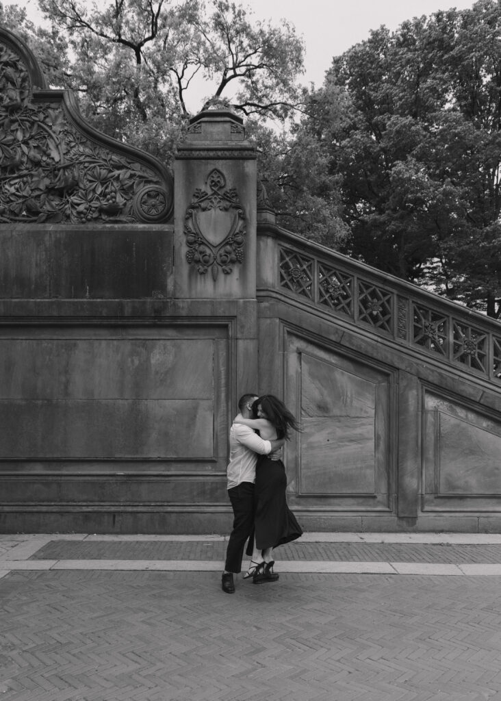 playful black and white engagement photo in central park