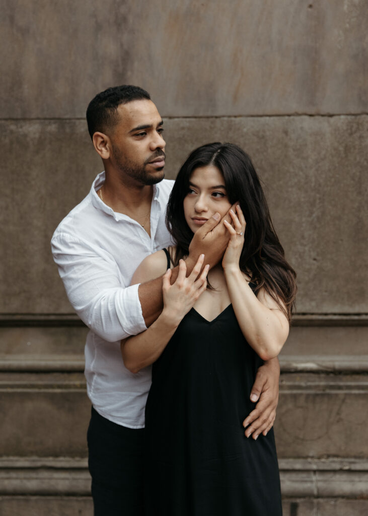 Playful Central park engagement photos at Bethesda terrace with sleek black dress and classy casual vibes