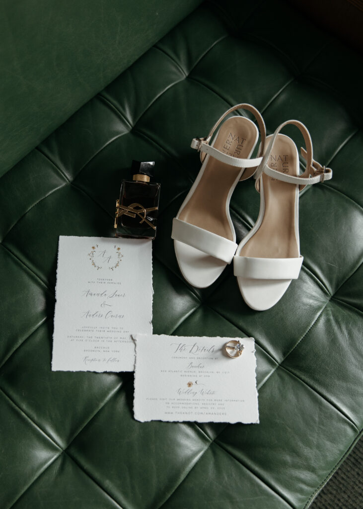 elegant wedding details on green leather bench
