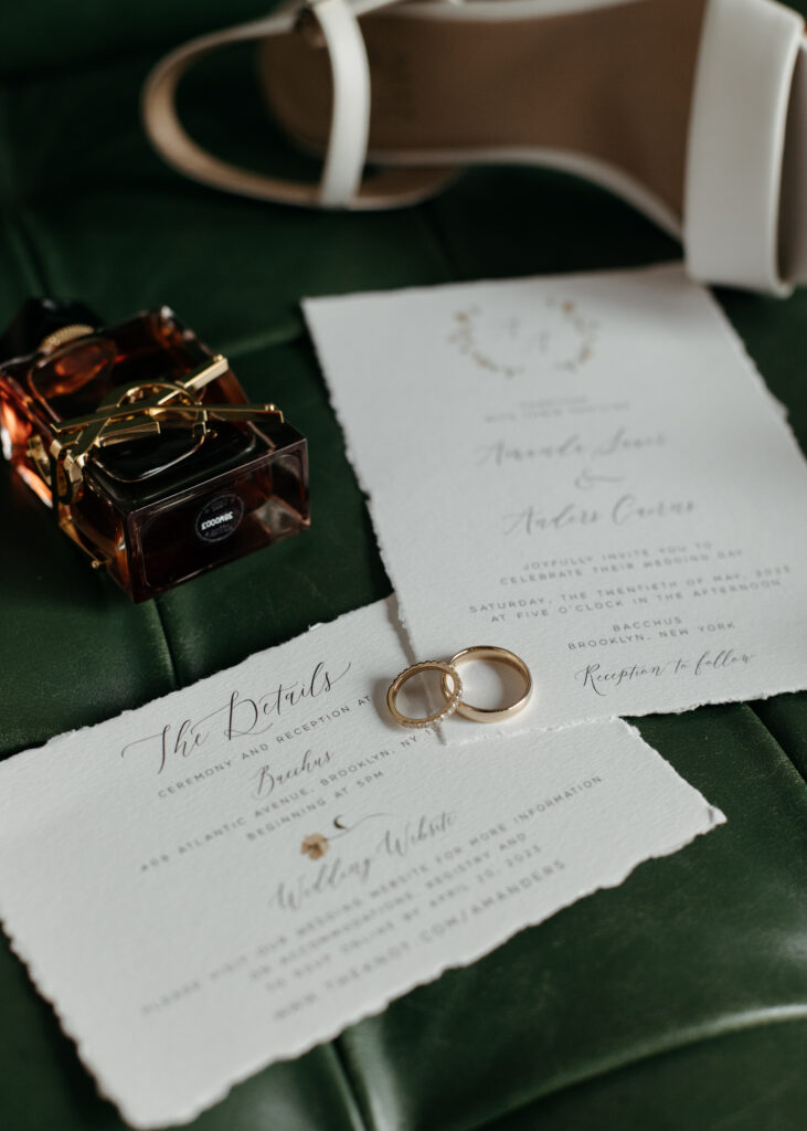 elegant wedding details on green leather bench