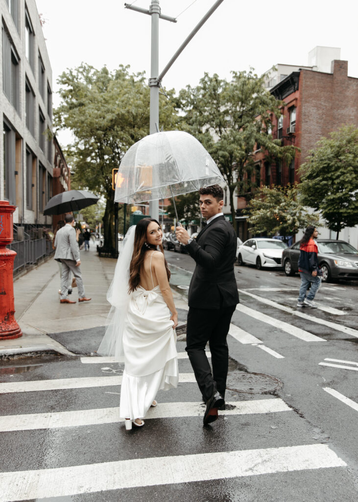 bride and groom downtown wedding photo in brooklyn with clear umbrellas