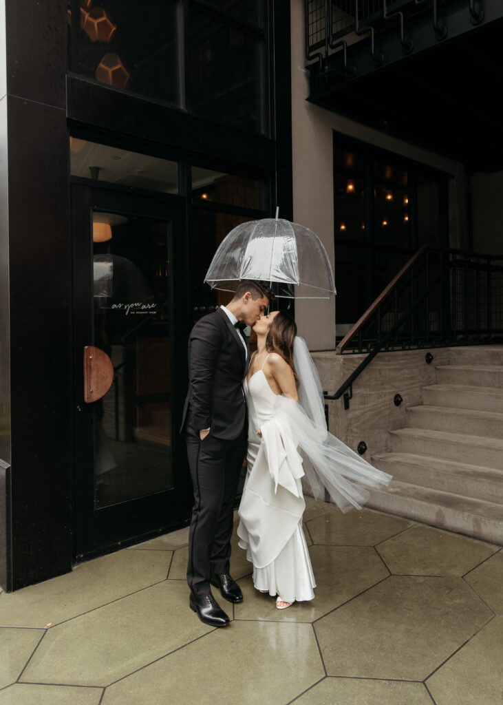 bride and groom downtown wedding photo in brooklyn with clear umbrellas