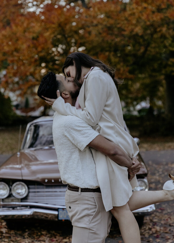 Romantic and playful couple during their fall engagement session outdoors