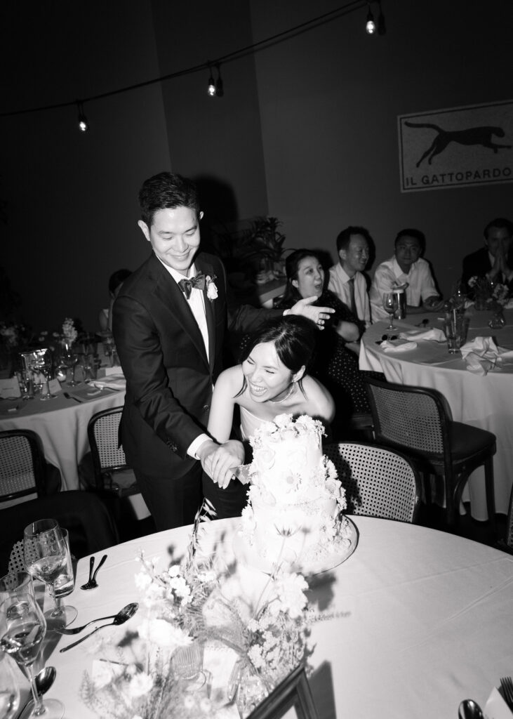 bride and groom cutting cake