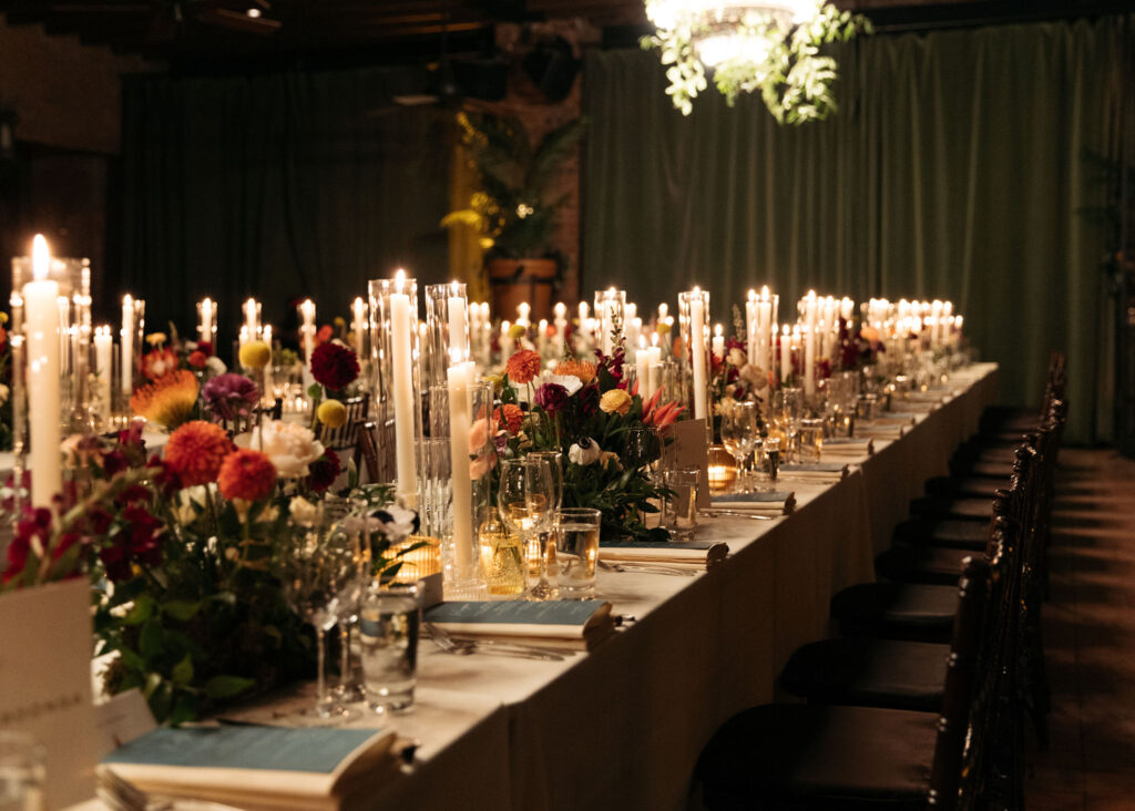 bowery hotel wedding reception decor of colorful florals and tall candles